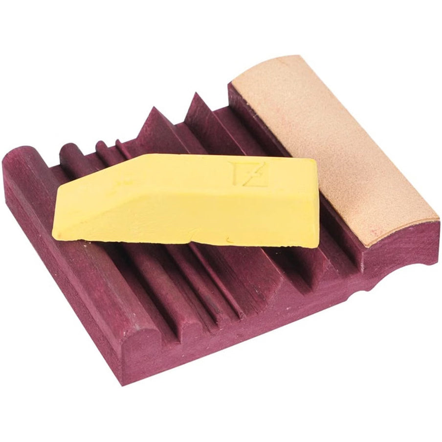 Flexcut Slipstrop carving tool sharpener with yellow polishing compound bar.