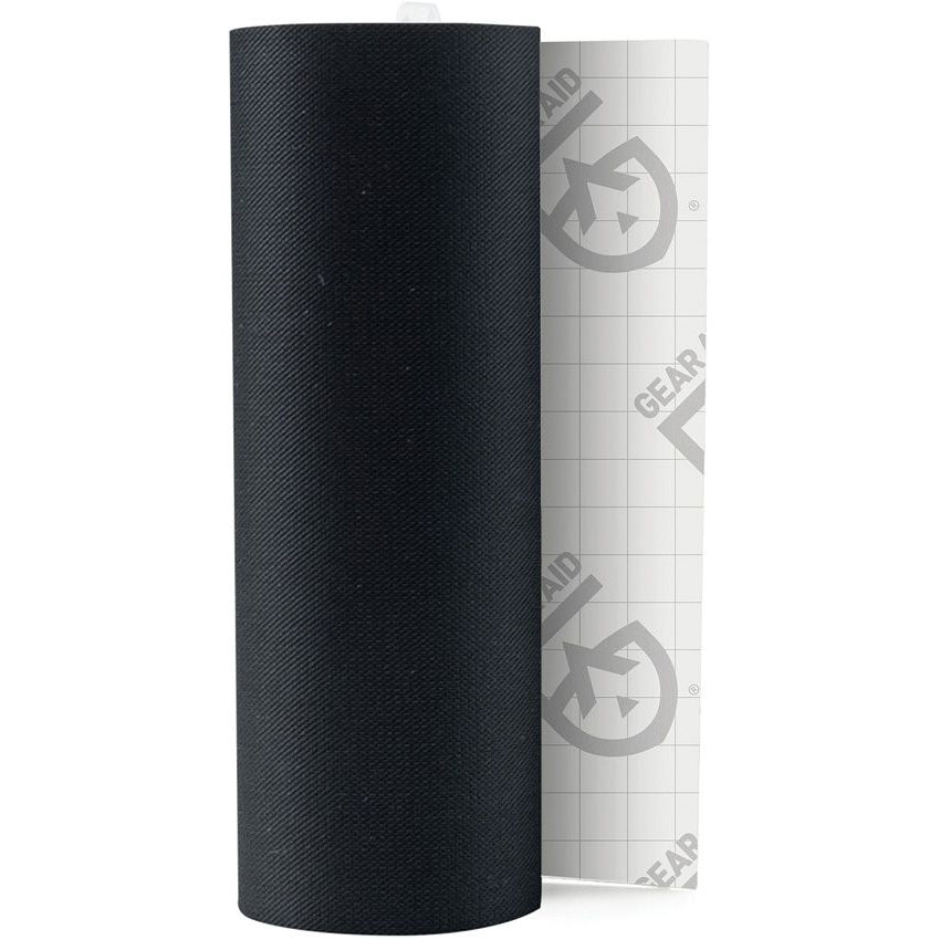 Gear Aid Tenacious Tape black nylon repair tape, unrolled with backing liner exposed.